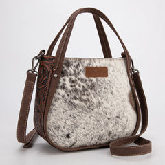 Wrangler genuine hair-on cowhide crossbody and tote bag in coffee, featuring natural cowhide texture, dual top handles, adjustable shoulder strap, and rustic Western leather patch