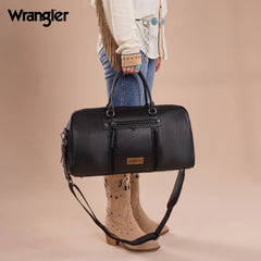 Cowgirl holding a black Wrangler whipstitch duffle bag with guitar strap – styled with Western boots and denim, perfect for weekend travel.